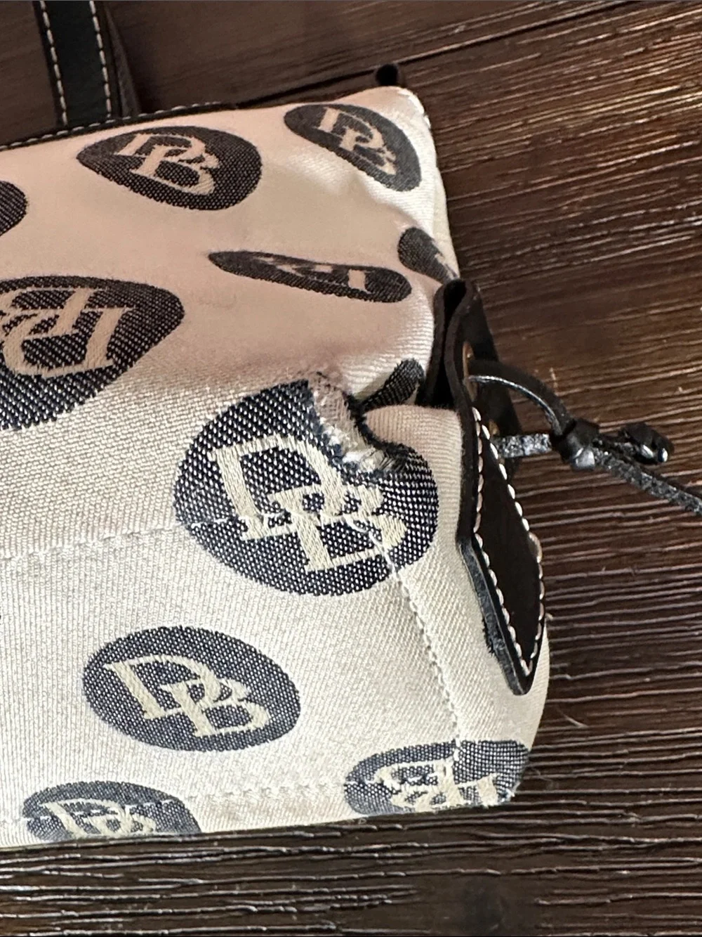 Dooney & Bourke Vintage logo jacquard handbag in cream and black.